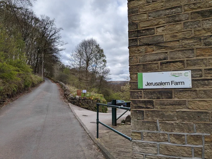 A stone building with a "Jerusalem Farm" sign on the side 