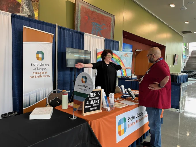 Two people at exhibit booth