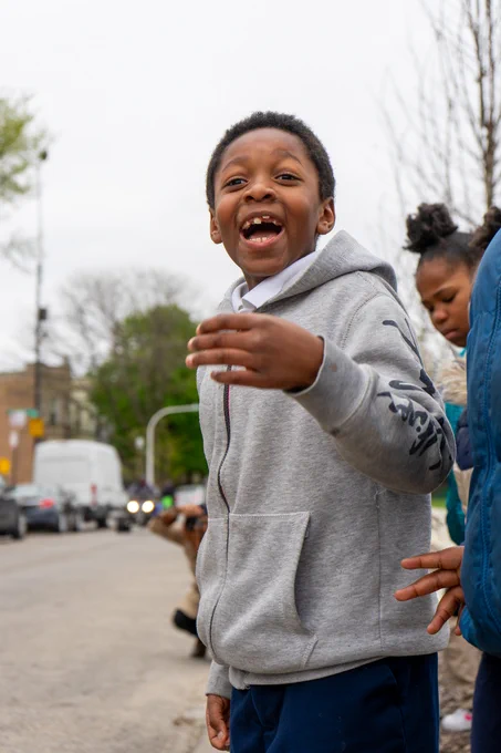 Young black boy, smiling with his mouth open in amazement. 