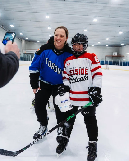 Lauriane Rougeau posing for a photo with a Toronto Leaside Wildcat.
