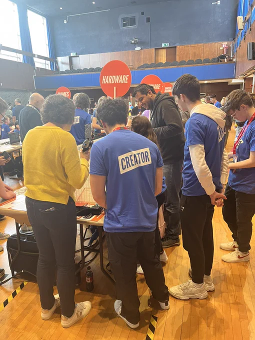 A judge from the Meta giving feedback to a young creator on their project