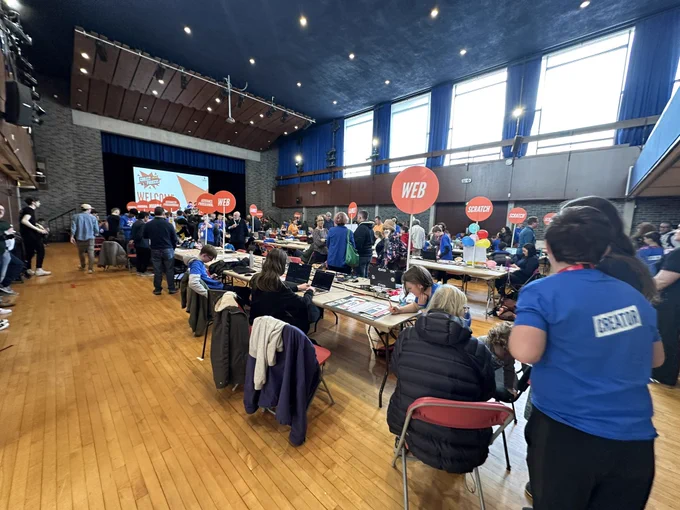 View of Coolest projects showing lots of young people and their tech creations