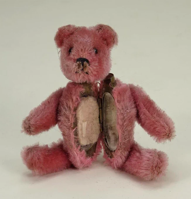 Vintage pink teddy bear with a powder compact as its mid-section