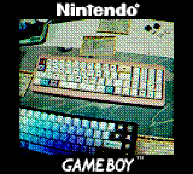 A photo of an elongated 40% pink keyboard taken with the GameBoy camera. It is difficult to make out details. 
