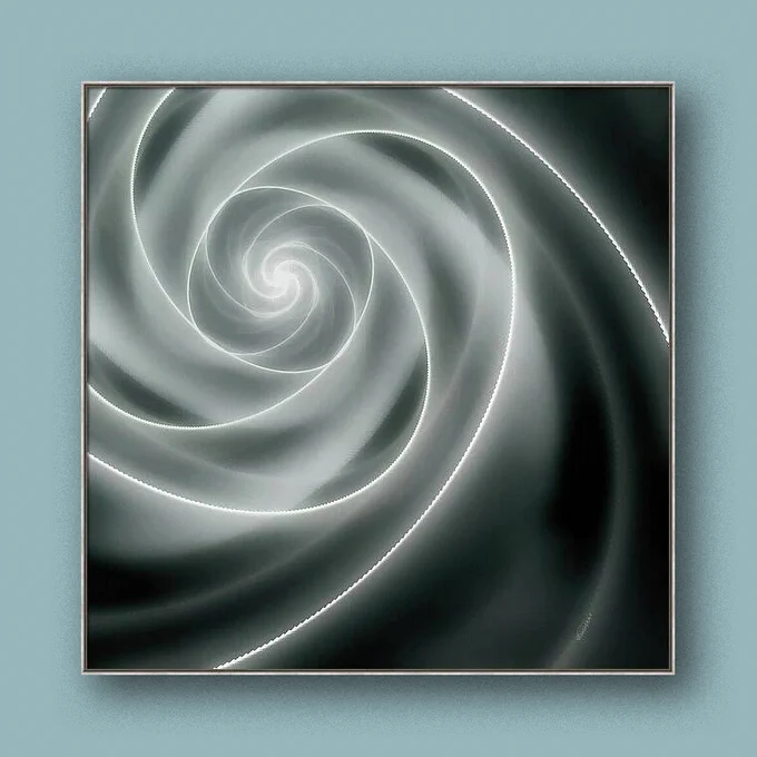 Shown on a wall, Number Four-Fourteen, new art from contemporary artist/photographer Jon Woodhams. Soft shades of gray create a mesmerizing spiral that draws the eye inward toward a central vanishing point, creating a sense of depth and movement and uses, while a subtle grain adds warmth and softness. 