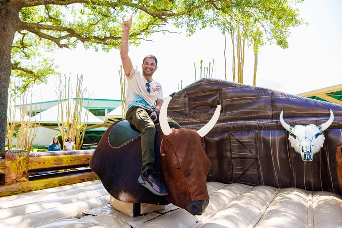 Student riding a mechanical bull