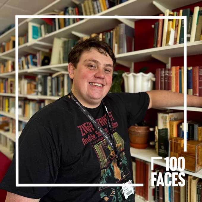 Maths student Jared in front of a bookcase. There is a 100 faces logo in the foreground.