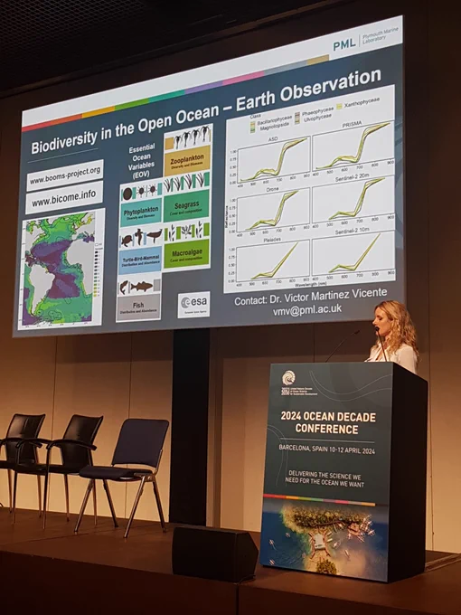 PML's Dr Claire Szostek presenting a slide on biodiversity monitoring from space - the slide mentions the BOOMS and BiCOME projects.