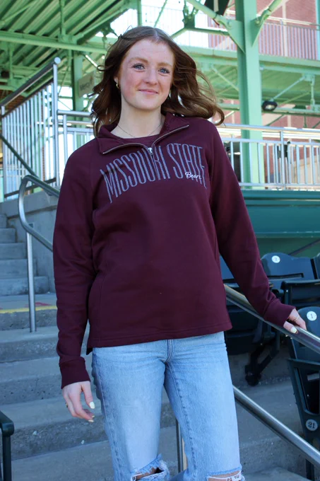 student walking down stairs in Missouri State quarter zip 