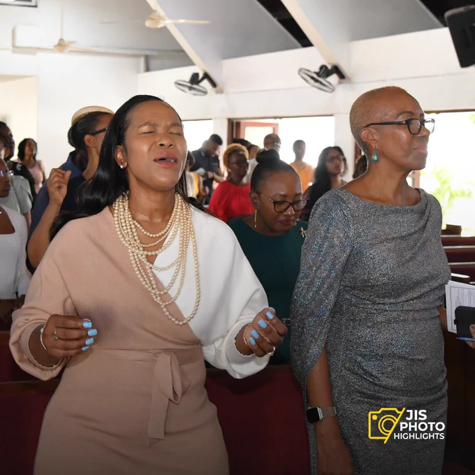 Permanent Secretary in the Ministry of Education and Youth, Dr. Kasan Troupe, and Portfolio Minister, Hon. Fayval Williams, keenly listening and grooving to the music at the launch of National Mathematics Week at the Webster Memorial United Church on Sunday (April 14)