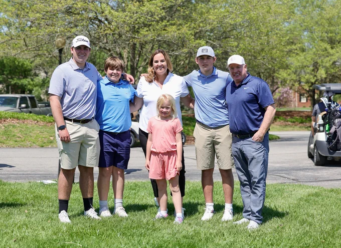 Coach Stoops and the Schlarman family pose for a photo