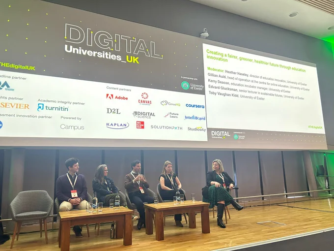 Speakers sat talking during panel session