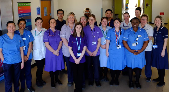 Group photo of the Stroke services team at Furness General Hospital standing in the hospital in uniform