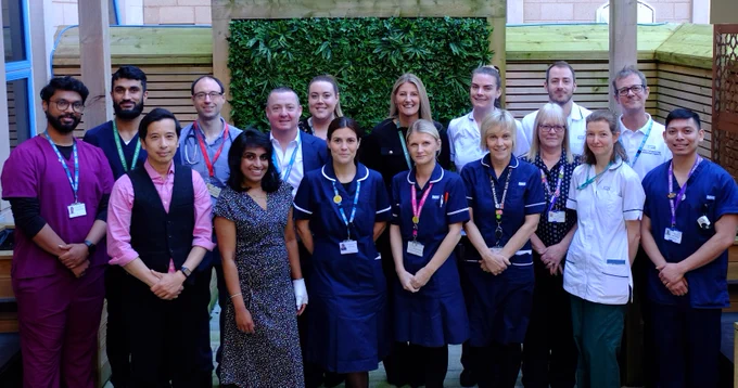 Group photo of the Stroke services team at Royal Lancaster Infirmary standing outside the hospital in uniform