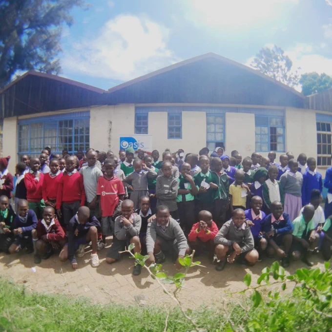A group of young people outside a school. 