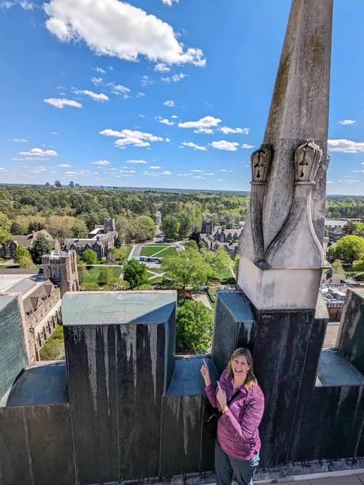 a person standing on landing at top of Duke Chapel with view of campus behind them