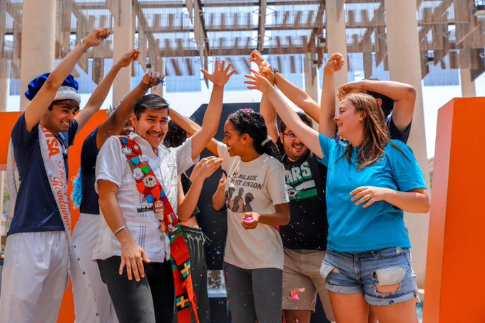 A group of students break cascarones over each other's heads