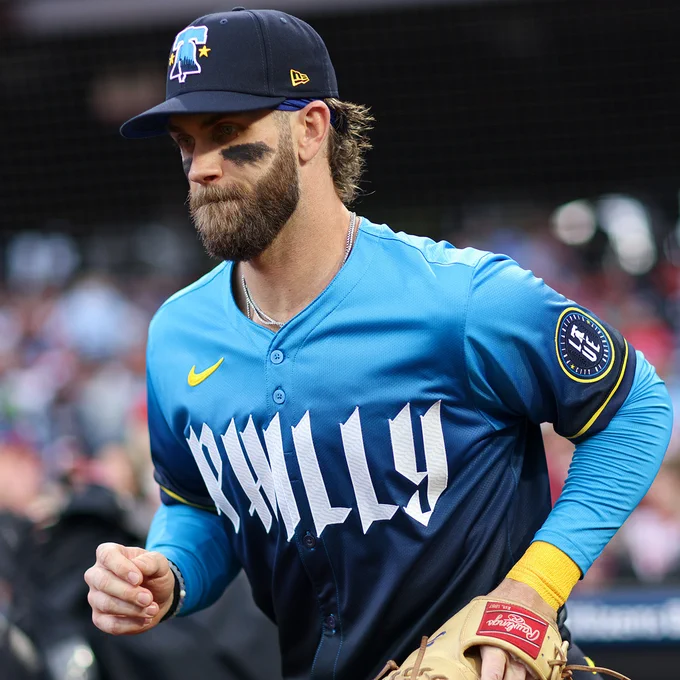 Bryce Harper running out on the field at Citizen Bank Park. He's wearing the Phillies City Connect uniform.