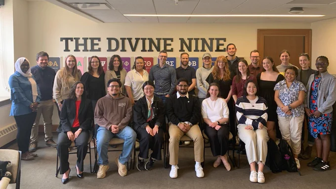 Students pose for a group photo with Ezra Klein