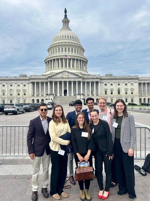 A group of graduate students posing in front of the US Capitol