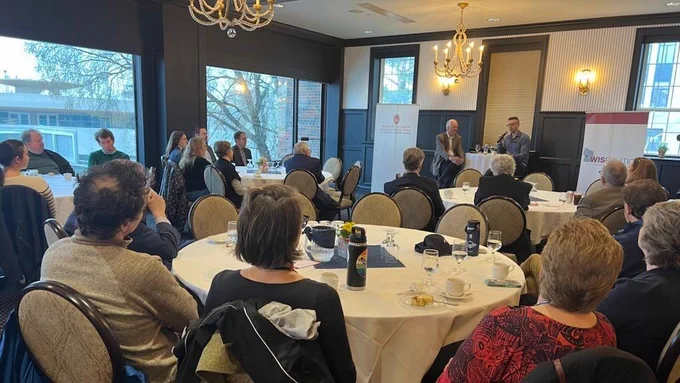 An audience in the Madison club watches Ezra Klein answer questions
