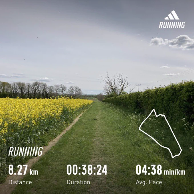 Path with hedges to the right, crops to the left. Running stats superimposed: 8.27km, 38:24