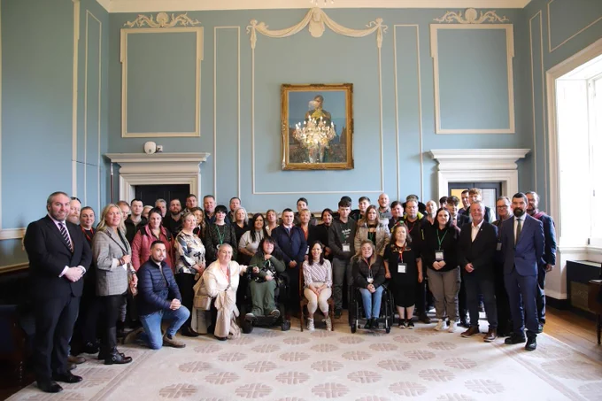 Group photo of Seanad Members and Traveller Community Representatives taken in the Ante Room of the Seanad Chamber.