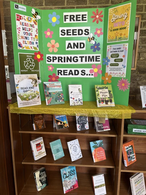 A poster board entitled " Free seeds and books to read" a selection of books related to growing and reading for pleasure are on display.