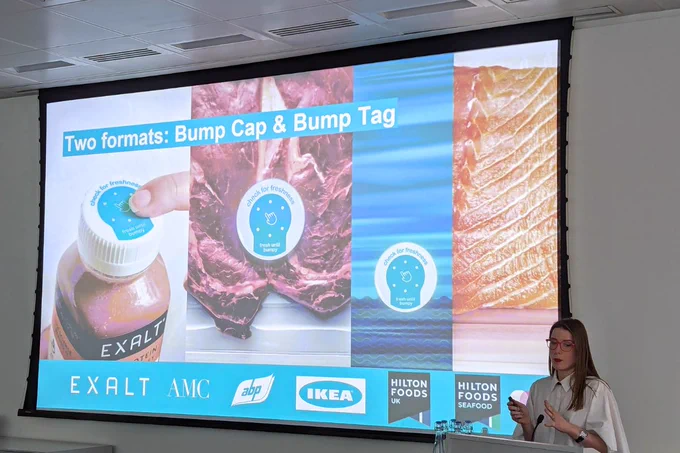 Solveiga presenting, showing slide of two Bump formats: cap and tag.