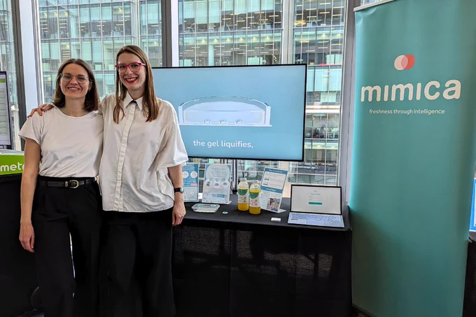 Founder and Director Solveiga Pakštaitė and Communications Manager Ieva Hofmane standing in front of Mimica booth at Barclays Corporate Connections Sustainability Showcase.