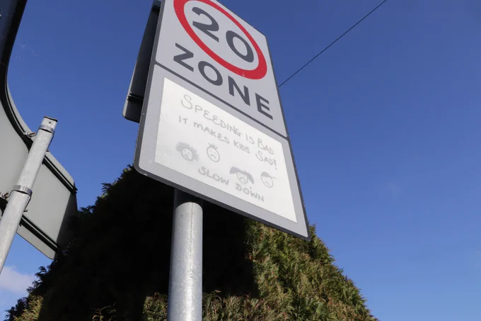 A 20 mile per hour sign in a residential street