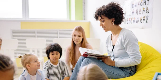 Woman Reading A Book To The Children