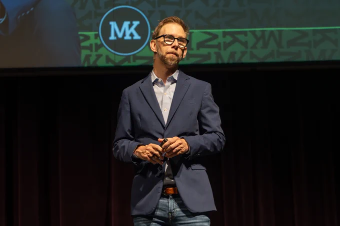 Michael Kutcher, keynote speaker for Mental Health Matters, talks on stage at Fossil Ridge High School.