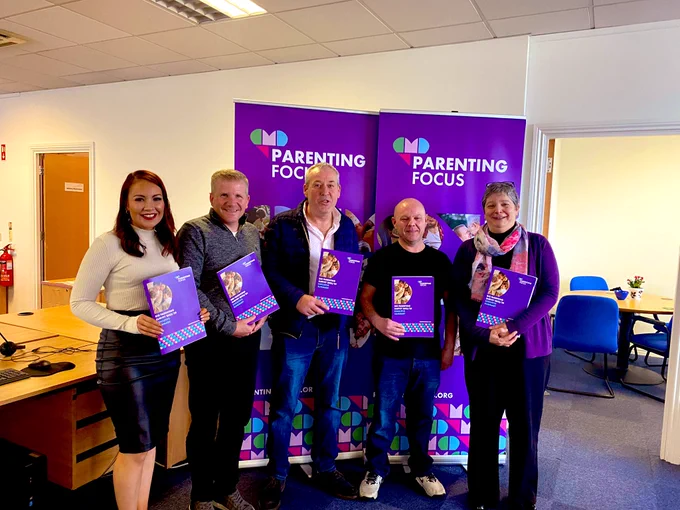 Chris with members of the Dads talk group, Koulla Yiosuma (interim parenting focus CEO) and Emma Hitchen Senior Participation and Research Officer all holding parenting focus survey