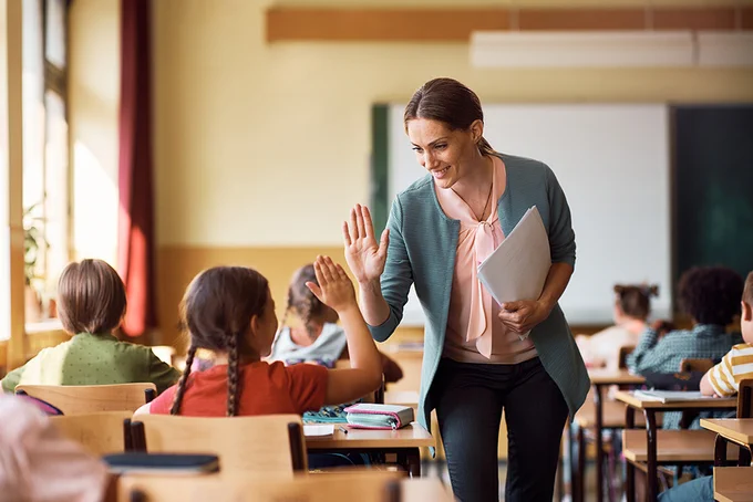 teacher high fiving student