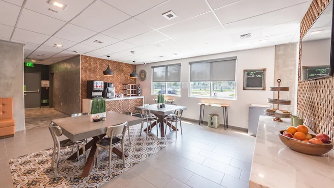 Lexen Hotel North Hollywood lobby area with tables and coffee station with artistic features for a break in the NoHo Arts district.