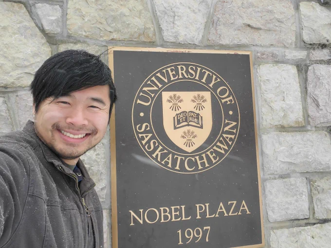 A selfie of me in front of a sign that says "University of Saskatchewan"