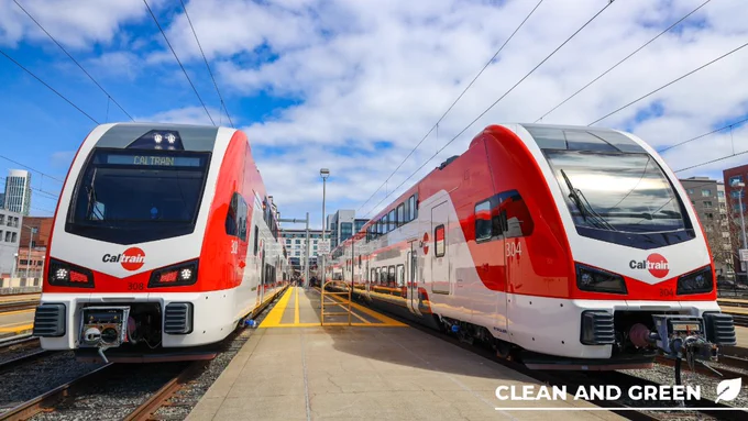 two electric trains in SF with a clean and green logo 