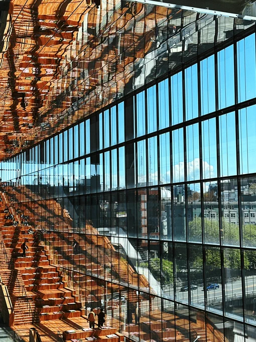 Interior of the Seattle Convention Center with steps and seating beside a huge set of window glass