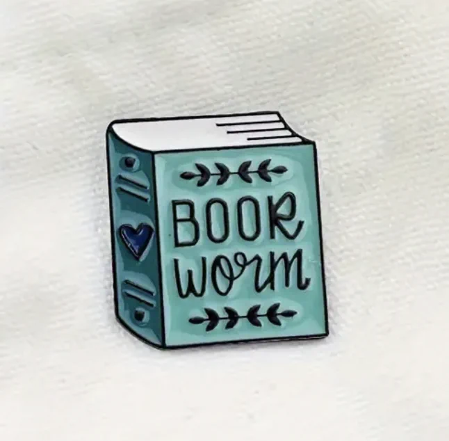 A small badge of a blue book that says, "Book worm".