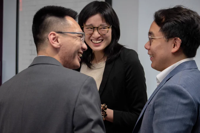 A Raben staff member laughs with two Congressional staffers