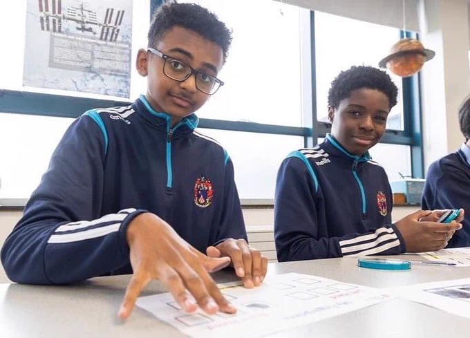 2 students pictured working in their fingerprinting at the forensics workshop