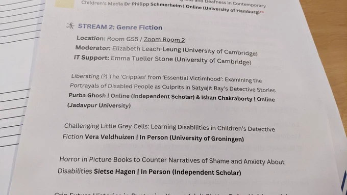 Photograph of paper conference programme with details of a panel on genre fiction 