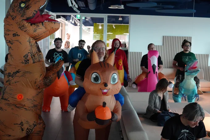 Different speakers of the event dressed in various blow up costumes like squirrel, dinosaur, flamingo, rooster and duck. 