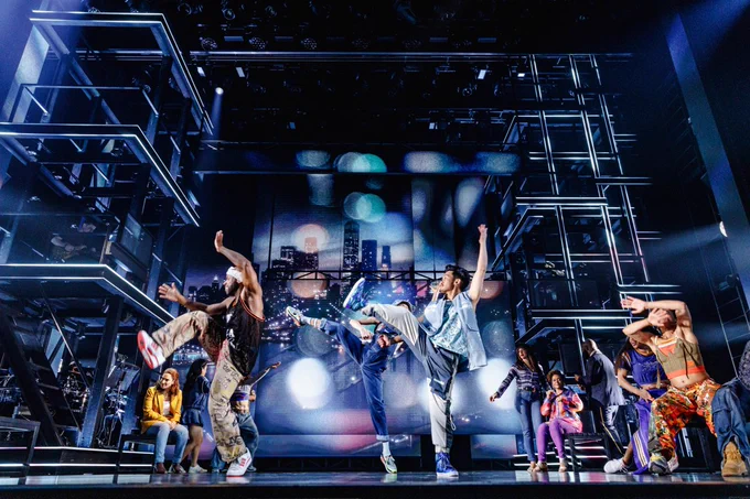 On-stage scenes from the Broadway Musical Hell’s Kitchen featuring actors singing dancing with street style clothes and colorful lights.
