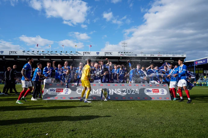 Pompey celebrate the League One title win.