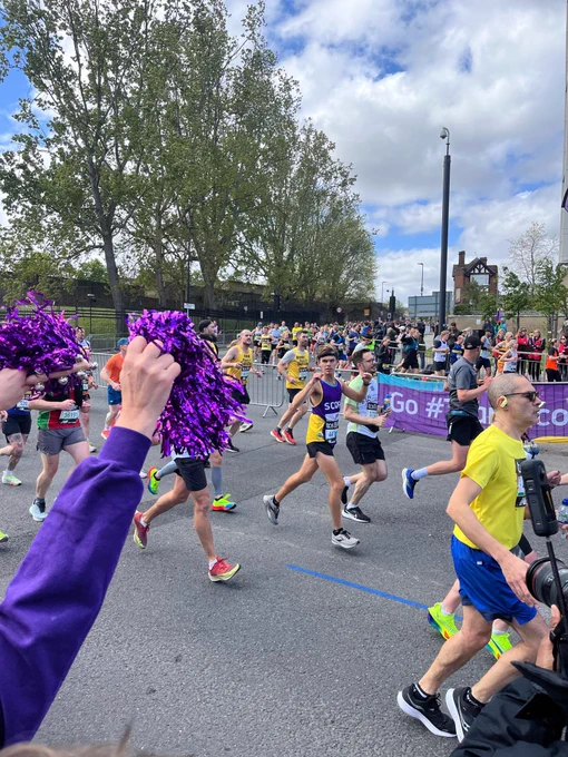 The Scope cheer squad cheering on a Team Scope runner at the London Marathon