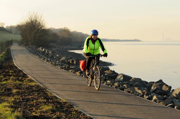 Photo of a person cycling on a path on the John Muir Way. Image credit: Lorne Gill/NatureScot
