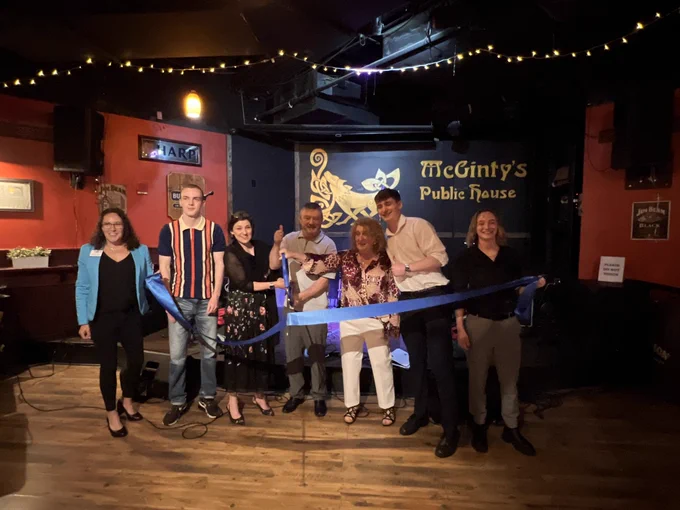 Council Vice President Stewart cutting the ribbon at  McGinty’s  Public House with Greater Silver Spring Chamber of Commerce and the Barry Family