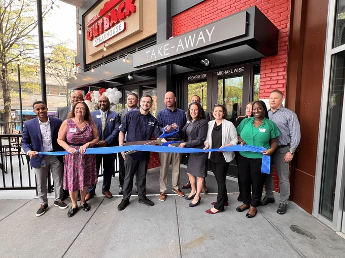Cutting the ribbon at the new Outback Steakhouse in downtown Silver Spring